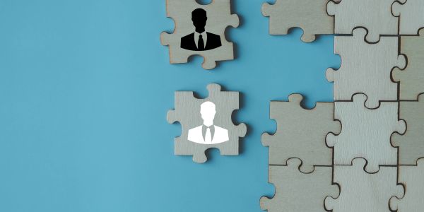 Puzzles pieces with black and white business icons.
