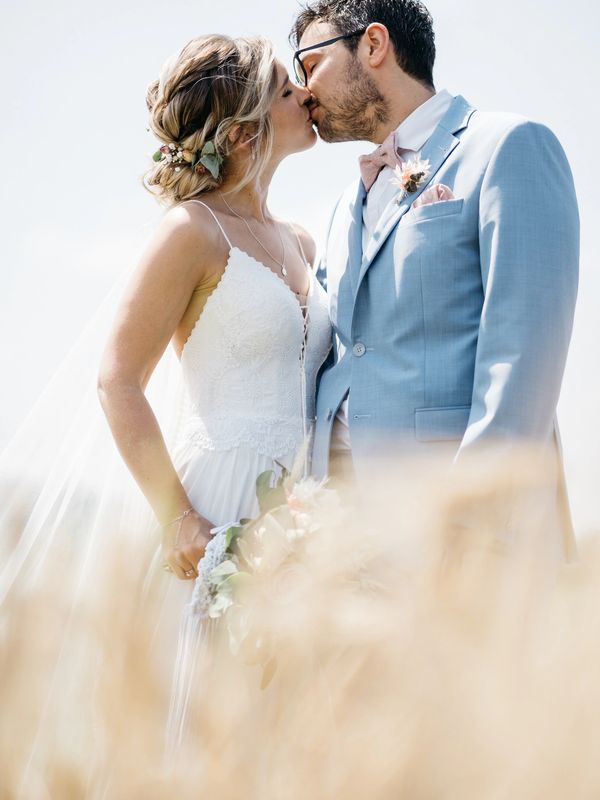 couple kissing during wedding day