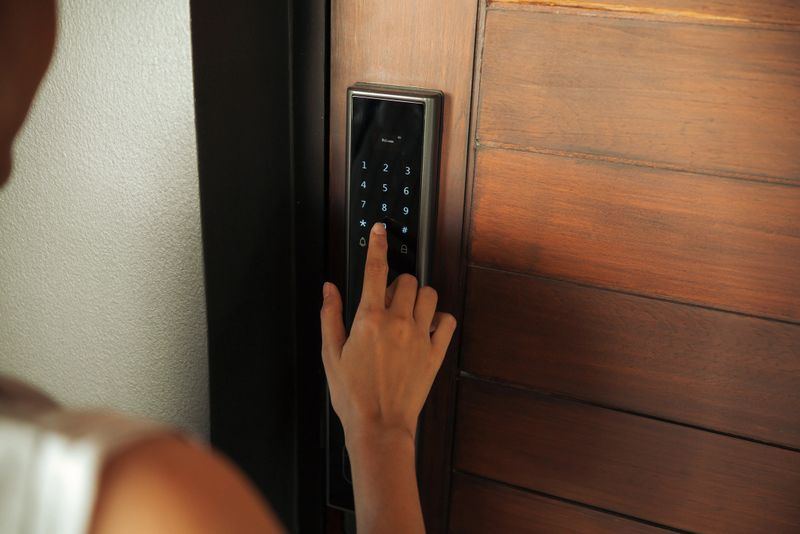Close-up Asian Woman hand Pressing down on electronic access control at door house. Doors And Locks With Technology