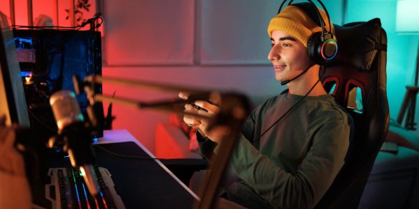 Young man gaming with headset and microphone.