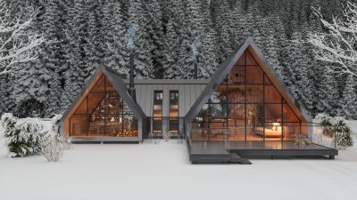 Modern A-frame cabin in snowy forest landscape.