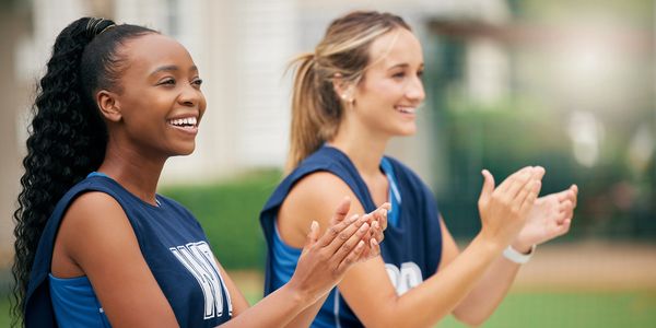 female girl woman women college athletes cheering on their team mates and winning