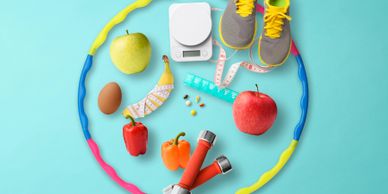 Healthy lifestyle essentials including fruits, dumbbells, and a jump rope on a blue background.