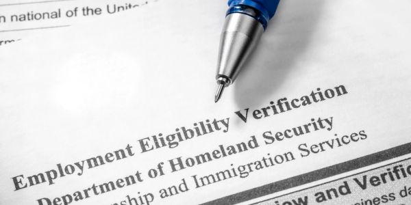 Employment eligibility verification form with pen.