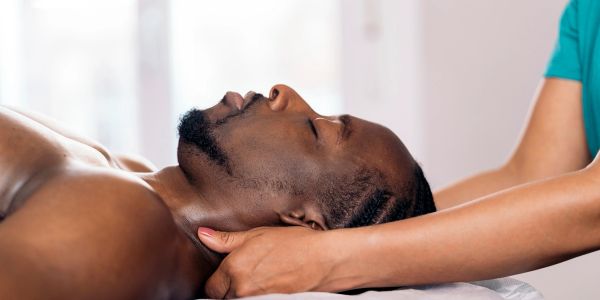 Man receiving a relaxing neck massage.