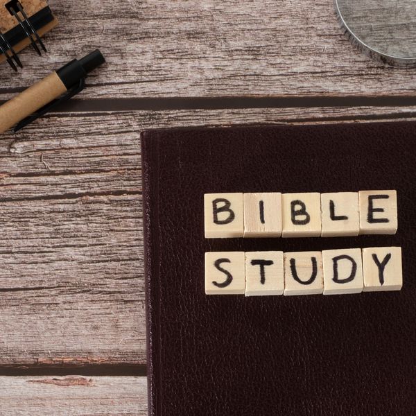 Wooden blocks spell "Bible Study" on a closed book.