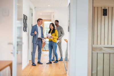Real estate agent showing a house to a couple.