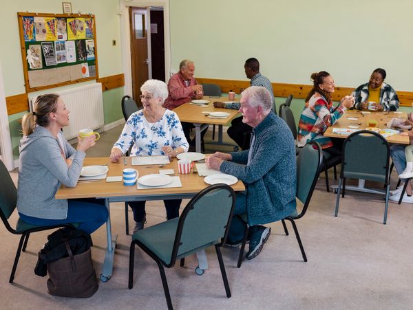 Group of people socializing in a community room.