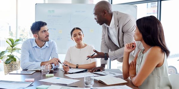 Team around a table discussing consulting services.