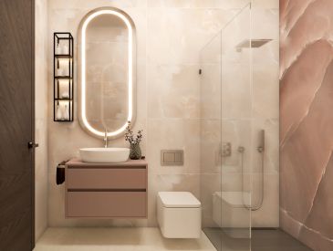 Baño moderno con espejo ovalado iluminado y ducha de vidrio.