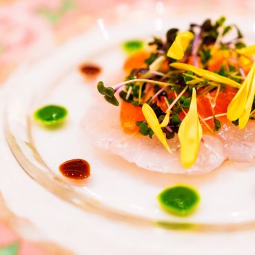 Elegant dish with microgreens and flower petals.