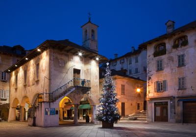 Historic town square with Christmas tree at dusk.