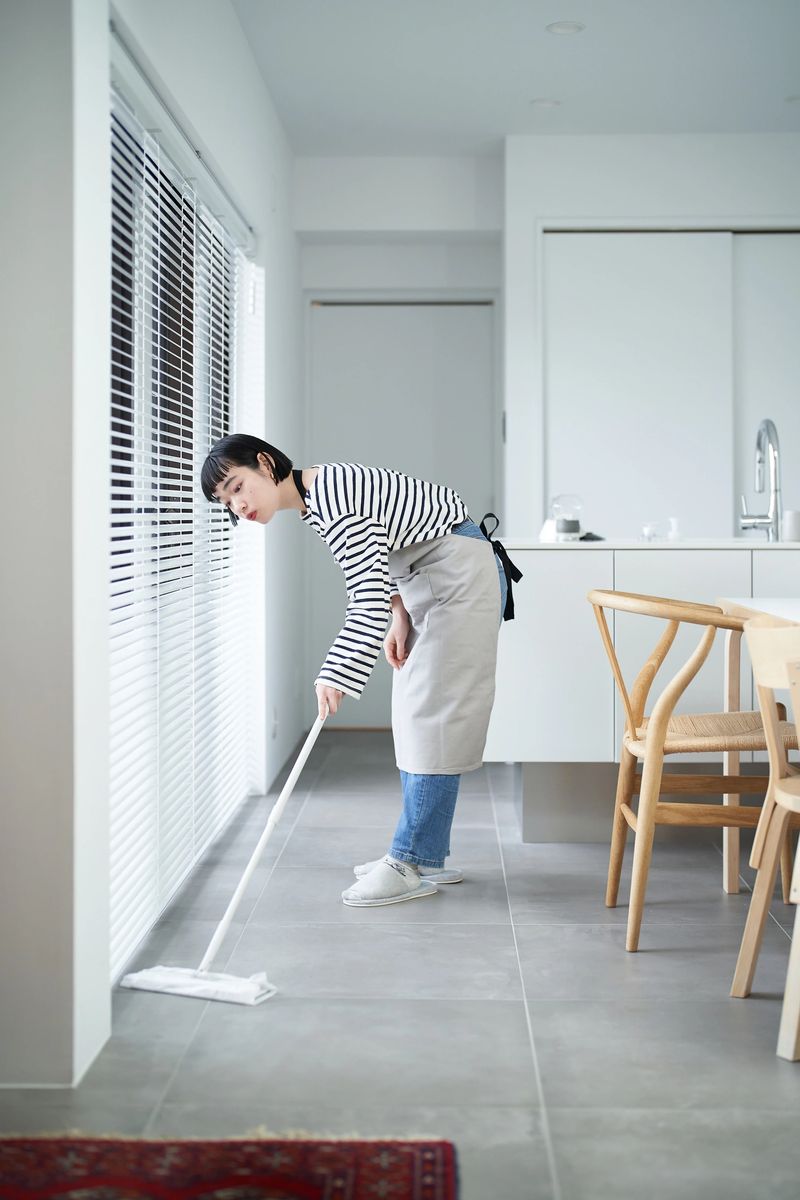 Asian young woman cleaning the floor in the room
