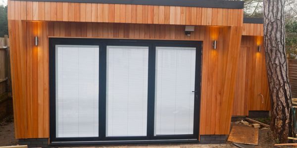 Garden Rooms with Aluminium B-ifold doors and Cedar cladding.
