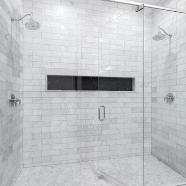 Custom walk-in shower installation with frameless glass and tile by Renovate & Elevate LLC in Tampa.
