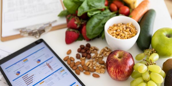 Healthy foods and nutrition data on a tablet.