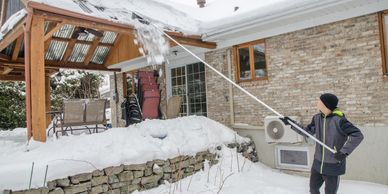 Snow being removed from a customer's rooftop in Osceola.