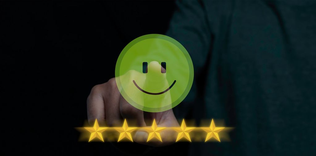 Hand presenting five glowing stars with a smiley face.