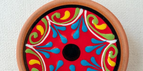 Colorful decorative circular art piece with vibrant patterns.