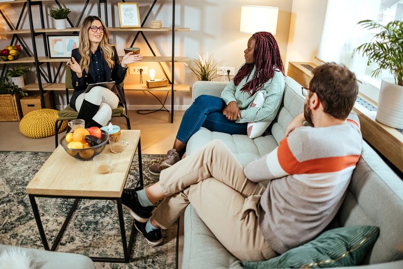 Worried couple meeting social counselor