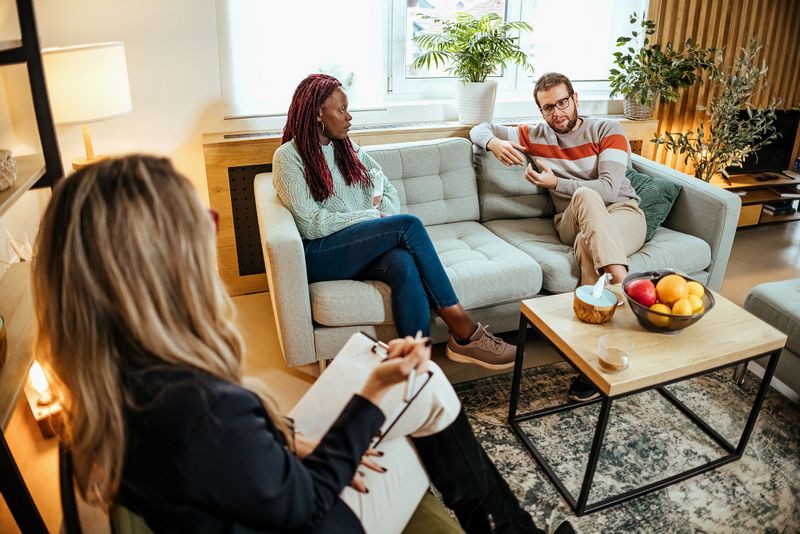 Worried couple meeting social counselor