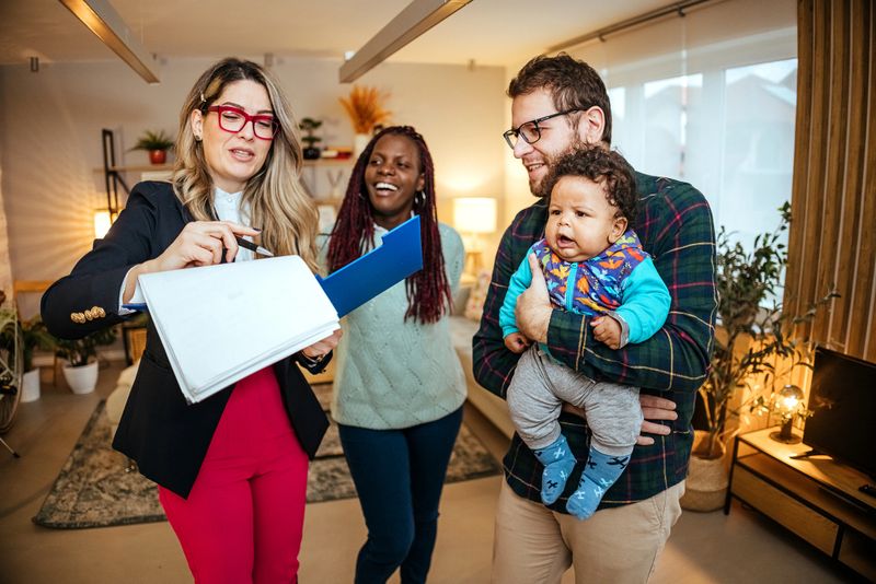 Real estate agent welcoming a family in to a new home