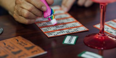Person applying bingo dauber on a bingo card.