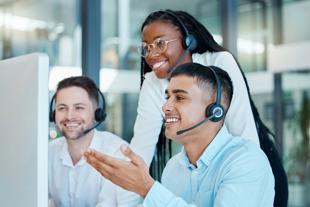 Group of thee around computer