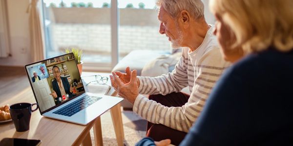 two adults and one therapist in what looks like a family or couples telehealth therapy session