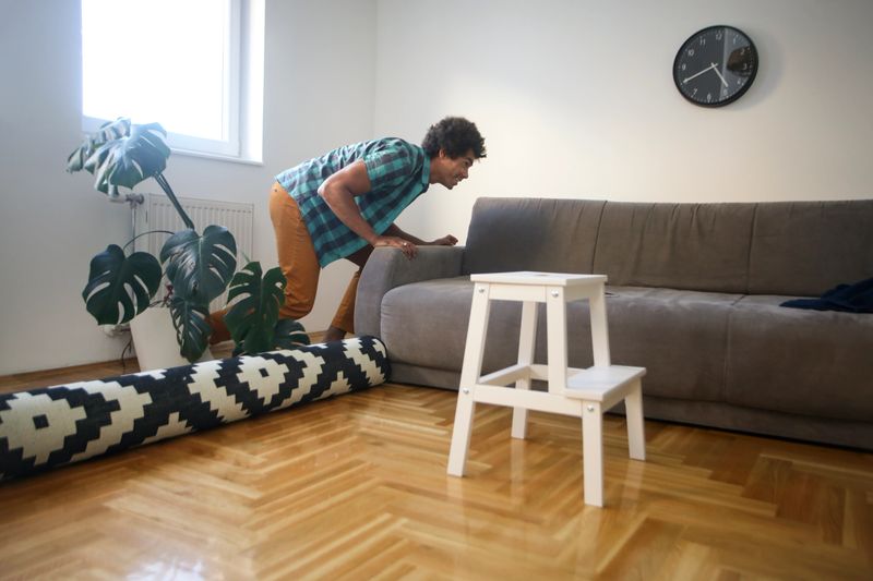 Mid adult man moving in his new home. About 35 years old, mixed-race male.