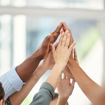 A group of people with their hands in the air.