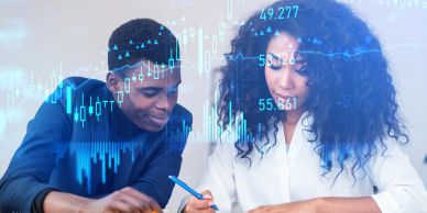 Two people analyzing data charts together.