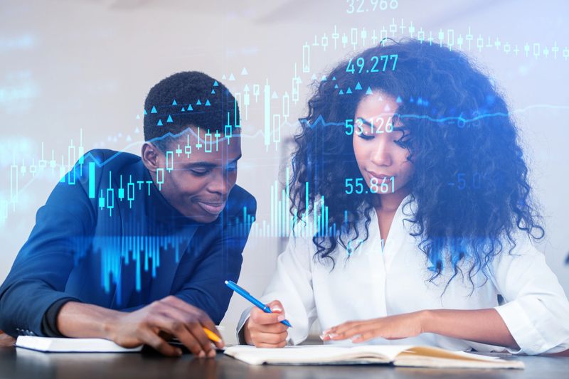 Black businessman and businesswoman working together, double exposure with glowing stock market chart and forex diagrams. Concept of teamwork and education