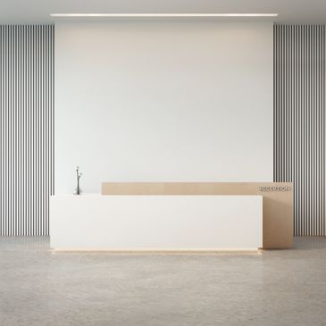 Minimalist reception desk with clean lines and subtle decor in a modern space.