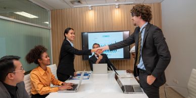 Business people shaking hands during a meeting.