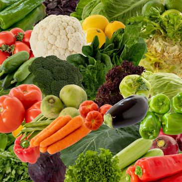 A vibrant assortment of fresh vegetables including tomatoes, carrots, broccoli, and peppers.