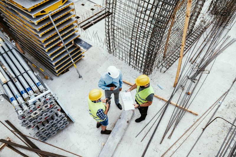 Candid shot of engineers and contractors on construction site
