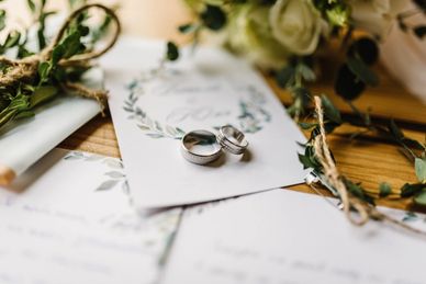 Two wedding rings on a wedding invitation card.