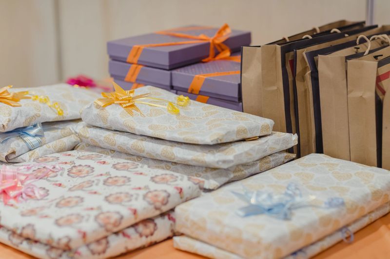 Christmas decoration. wedding  presents in boxes on a wooden background with copy space. Golden baubles. Christmas theme.