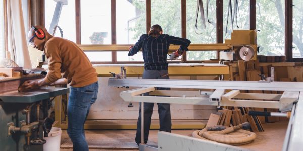 Two men working in a woodworking shop.
