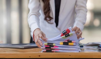 Stack of legal case files and court papers on a desk