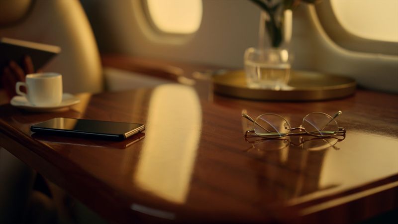 Businesswoman working tablet computer. Closeup luxury airplane interior details. Focused attractive lady working with digital pad. Smiling woman traveling in private jet. Wealthy lifestyle concept.