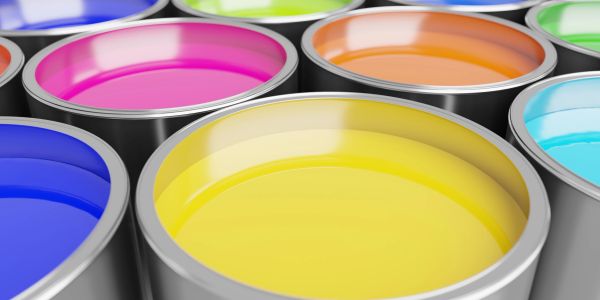 Open cans of colorful paint arranged closely.