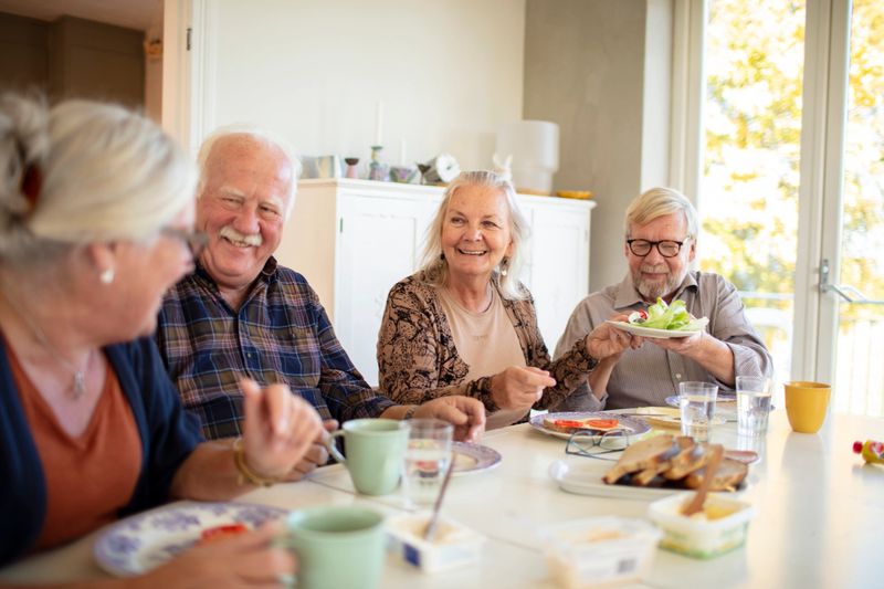 Close up of a small group of seniors having breakfast together