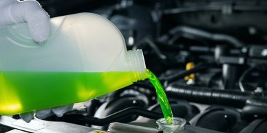 coolant being poured into the coolant tank of car 