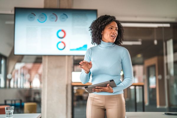Woman giving a presentation with a tablet.