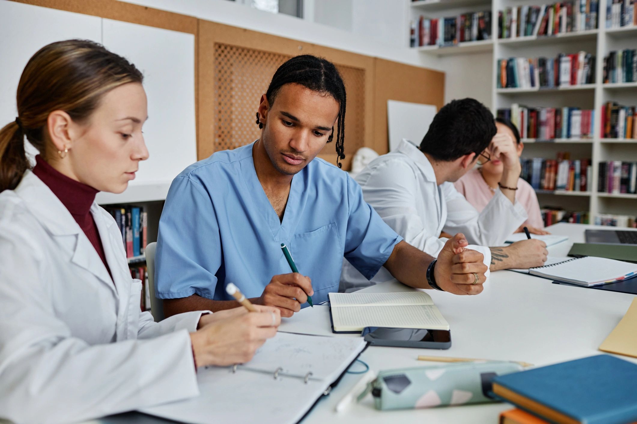 Medical students studying together in a library.