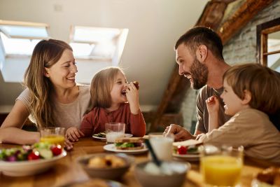 Happy family enjoying breakfast together.