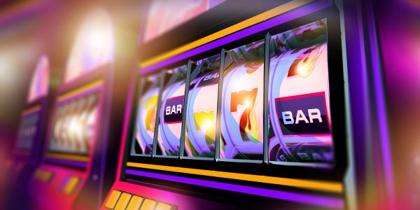 Close-up of a colorful slot machine showing bars and sevens.