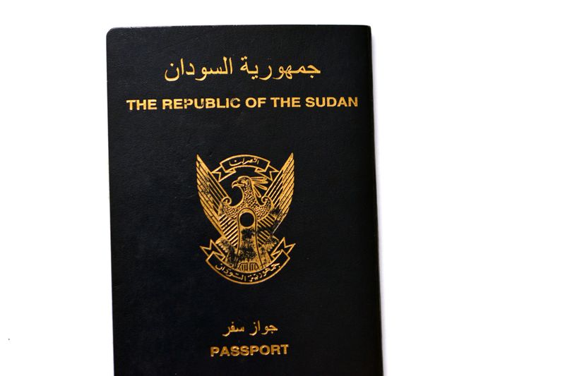 The Republic of Sudan passport with a gilded falcon in the center of the front cover, selective focus of Sudanese passport identity of North Sudan used for having visa stamps during traveling, selective focus